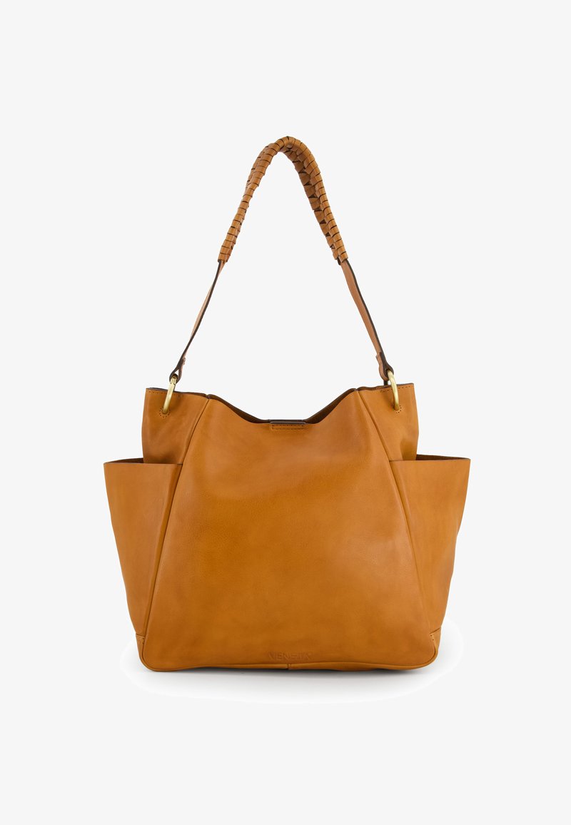 Tan leather tote bag with a braided handle, curved shape, and exterior side pockets. Smooth texture and minimal detailing.