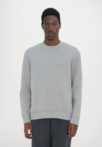 Gray sweatshirt made of soft cotton blend, featuring a crew neck, long sleeves, and embossed "Armani Exchange" logo on the front.