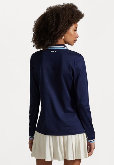 Navy long-sleeve shirt with a contrasting striped collar, featuring "RLX" logo on the back and a smooth cotton texture.