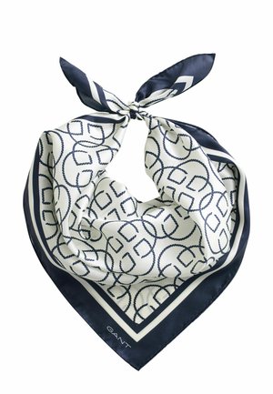 Weißer und marineblauer Seidenschal mit marineblauem geometrischem Knotenmuster und Rand, oben zu einem Knoten gebunden, mit dem Text "GANT" an einer Ecke.