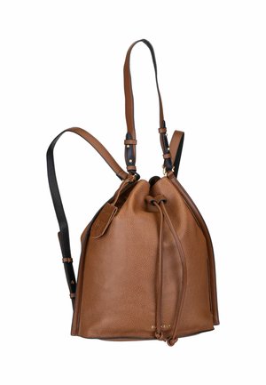 Brown leather drawstring backpack with textured finish, adjustable black straps, gold hardware accents, and a logo tag on the side.