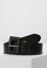 Black leather belt with a textured finish, featuring a rectangular silver metal buckle, stitched edges, and a tapered end for adjustment.