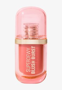 Superdewy Blush Burst in a clear cylindrical bottle with a pink cap, gold accents, and a peach blush product visible inside.
