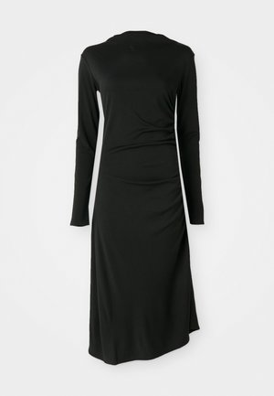Black long-sleeve dress with a fitted silhouette and side ruching detail. Made of smooth, stretchy fabric with a modest round neckline.
