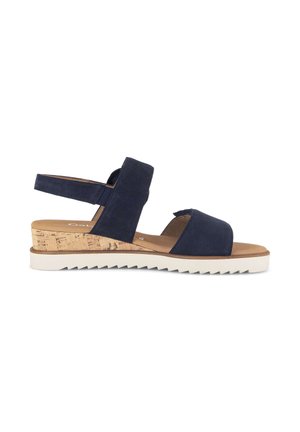 Navy blue sandal with two wide fabric straps, cork wedge heel, and white ridged rubber sole, viewed from the side.
