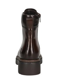 Botín de cuero marrón con acabado suave, cremallera lateral y suela gruesa. Presenta un lazo en la parte trasera para facilitar el calzado.