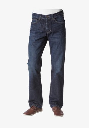 Men's dark blue straight-leg jeans paired with brown leather casual shoes on a white background.