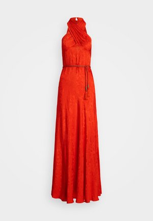 Red halter-neck dress with a textured floral pattern, featuring a fitted bodice and a flowing skirt, cinched with a matching braided belt.
