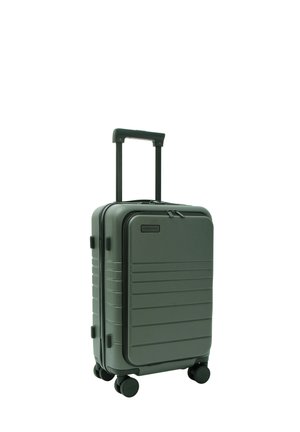 Valise rigide compacte vert foncé avec quatre roues, poignée télescopique déployée et poche avant zippée.