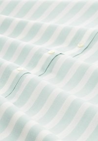 Light blue fabric with white horizontal stripes, featuring a smooth texture and visible button details. Suitable for casual clothing.