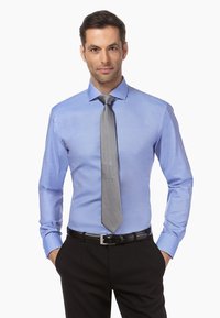 Lichtblauwe overhemd met lange mouwen, semi-spread kraag, gecombineerd met een grijze stropdas en een zwarte riem, gedragen met zwarte broek.