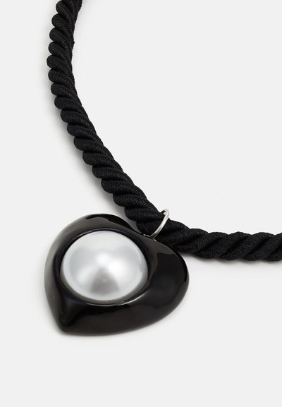 Black rope necklace with a glossy heart-shaped pendant featuring a large silver-colored pearl in the center.