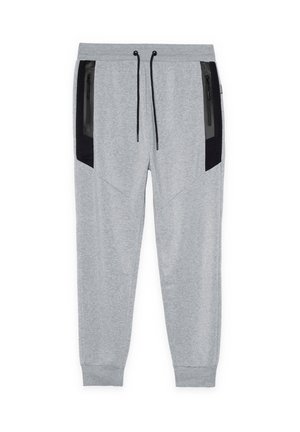 Pantalones jogger gris claro con bolsillos laterales negros con cremallera, cintura elástica con cordones negros y tobillos con puños.