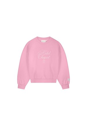 Pink crewneck sweatshirt with "Hotel Chapot" script text in white on the front and a small patch on the left sleeve cuff.