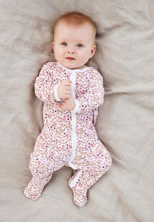 White floral-patterned baby onesie with pink and beige flowers. Features long sleeves and a front snap closure. Soft fabric, snug fit.