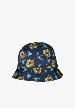 Navy blue bucket hat with repeating smiling yellow cartoon character and light blue palm tree and pineapple patterns.