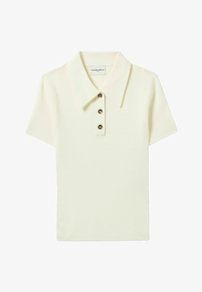 Polo shirt crema a maniche corte con texture a costine, colletto classico e patta con tre bottoni. Etichetta visibile all'interno del colletto.