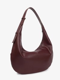 Burgundy leather hobo bag with a curved shape, zippered closure, and adjustable strap featuring silver hardware accents.