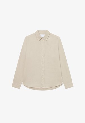 Beige színű, hosszú ujjú ing könnyű anyagból. Gombos gallérral, elülső gombokkal és egy diszkrét logóval rendelkezik a mellkasán.