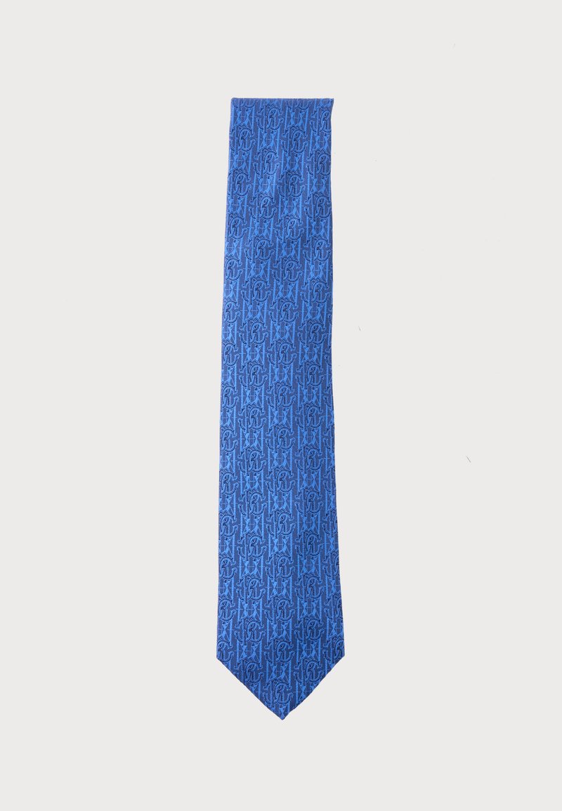 Cravate bleue avec un motif répété de lettres entrelacées bleu foncé et de formes d'étoiles sur un fond clair.