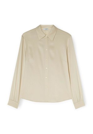 Jasno beżowa koszula z długim rękawem, z klasycznym kołnierzykiem, zapięciem na guziki i bocznymi zakładkami. Wykonana z gładkiego materiału o luźnym kroju.