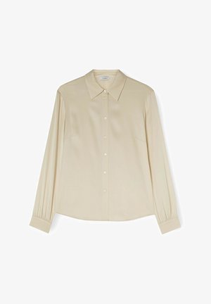 Camicia a maniche lunghe color beige chiaro con colletto classico, chiusura a bottoni e pieghe laterali. Realizzata in tessuto morbido con una vestibilità rilassata.