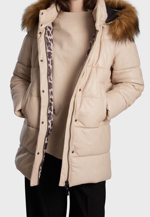Puffer jacket in beige with a brown fur hood. Features a leopard print lining and two front pockets. Zipper closure with snaps.