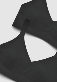 Reggiseno nero con tessuto liscio, design a forma di V e spalline regolabili. Chiusura semplice senza motivi o decorazioni distintive.