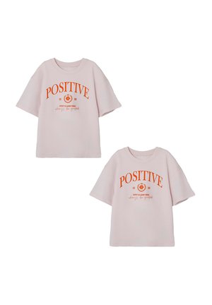 Pink cotton T-shirt with short sleeves, featuring orange "POSITIVE" text and a graphic design. Casual fit with a round neck.
