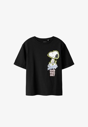 Black cotton t-shirt with short sleeves, featuring a Snoopy graphic and text "Good Vibes Only" in blue and pink. Round neckline, relaxed fit.