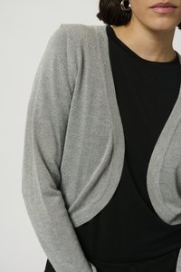 Gray, lightweight cardigan with a draped design and open front. Soft texture, long sleeves, worn over a black top. Simple, versatile look.