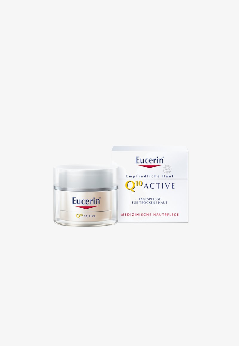Eucerin Q10 Active cream in a clear glass jar with a silver lid, packaged in a white box with blue text, designed for dry skin.