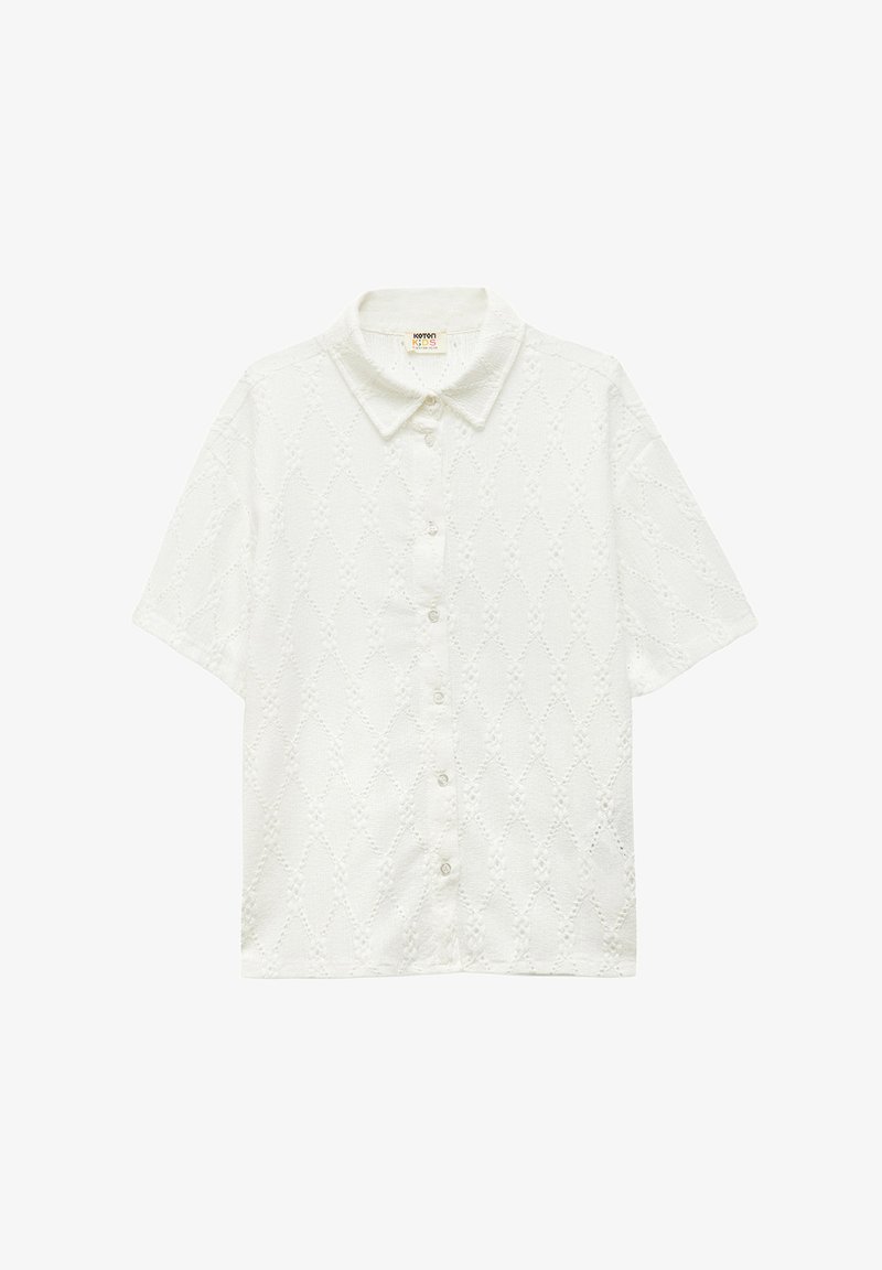 White short-sleeve shirt featuring a textured diamond pattern, button front, and a classic collar. Made of lightweight cotton material.