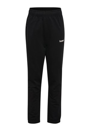 Sorte atletikbukser med elastisk talje, sidelommer med lynlås, tilspidsede ben og hvidt "hummel"-logo på det øverste lår.