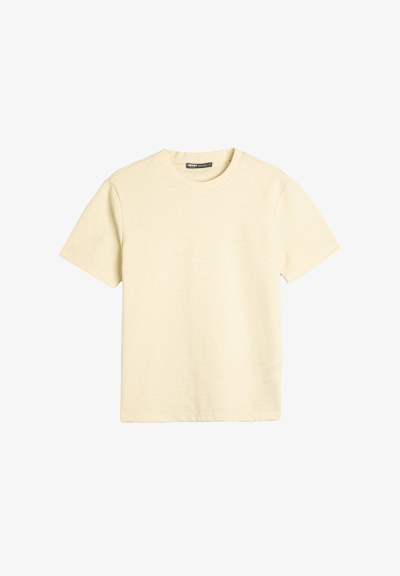 Kortærmet T-shirt med rund hals i lys beige, tekstureret stof med subtilt mønster, lige kant og afslappet pasform. Ingen synlige logoer eller grafikker.