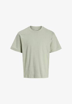 Vihreä puuvillapaita, jossa on klassinen pyöreä pääntie, lyhyet hihat ja rento leikkaus. Suoratekoinen rakenne ilman näkyviä kuvioita tai yksityiskohtia.