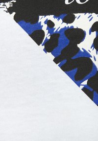 Baumwollstoff mit diagonalem Design, das weiße, schwarze und blaue Leopardenmuster-Akzente aufweist, die sich von einem einfarbigen weißen Bereich abheben.