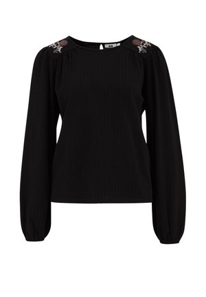 Musthave mustra, mis on valmistatud pehmest ja tekstuuriga kangast, ümmarguse kaelusega ja õlavarre õmblustes broderi lillemotiividega. Laia lõikega ja puhvse varrukatega.