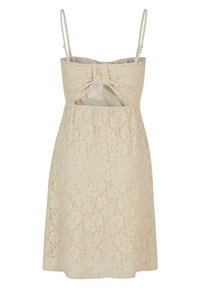 Robe sans manches en dentelle beige à motif floral, bretelles fines réglables, détail nœud et découpe frontale sous la poitrine.