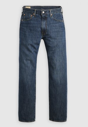 Dark blue denim jeans with straight legs, five pockets, contrast stitching, and a classic button fly. Features a leather back patch.