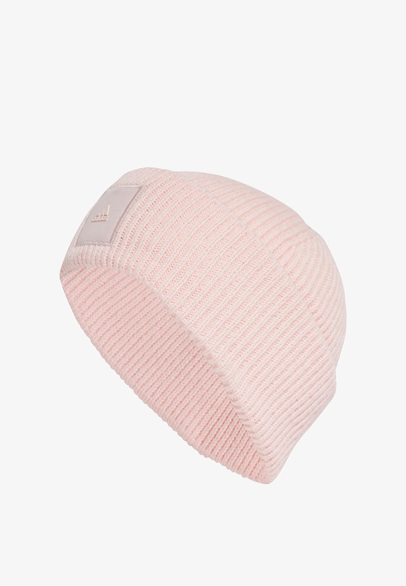 Light pink knitted beanie with a ribbed texture, featuring a small square patch with a logo on the side. Soft, stretchable material.