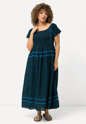 Vestido maxi de algodón azul oscuro, con mangas cortas, torso texturizado y acentos geométricos azules en el dobladillo y la cintura.