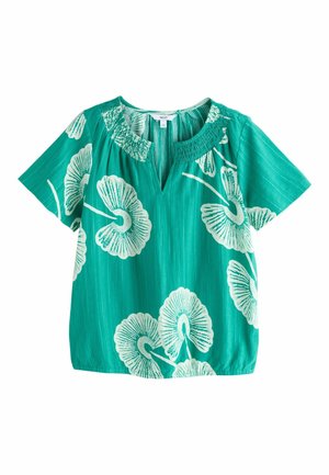 Blouse courte à manches courtes bleu sarcelle avec imprimé floral blanc, encolure ronde smockée et petit détail en V à l'avant.