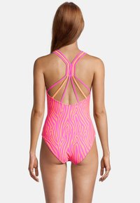 One-piece swimsuit in vibrant pink with a zebra stripe pattern, featuring a strappy back design in contrasting colors and smooth texture.