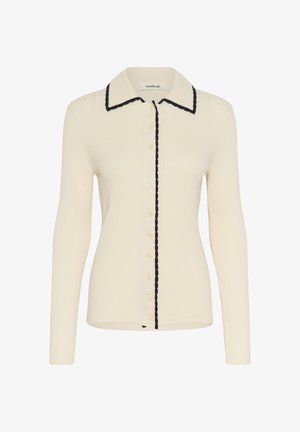 Pikad варог cream ribad jakk, millel on nööbiga eest, terav krae ja musta lainelise äärisega krae ja nööpide rivi.