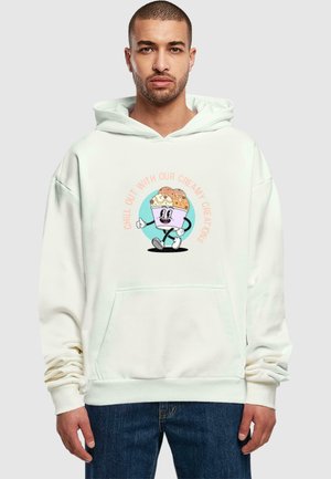 Cream-colored hoodie with a front pocket. Features a cartoon ice cream character print in pastel colors and text: “Chill Out With Our Creamy Creations.”