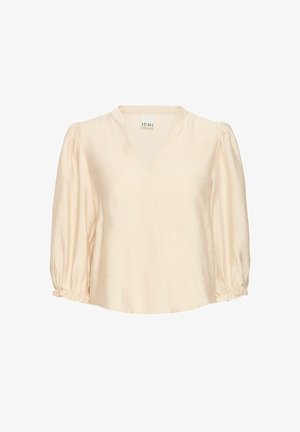 Gaišbeige blūze ar V veida kakla izgriezumu, trīs ceturtdaļu puff piedurknēm, savelkošiem izstrādājumiem pie aprocēm un mīkstu, teksturētu audumu. Zīmola etiķete redzama.