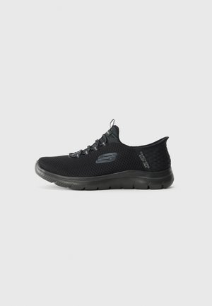 Black slip-on Skechers athletic shoe with mesh fabric, flexible sole, and pull tab on tongue, shown in left side profile on white background.