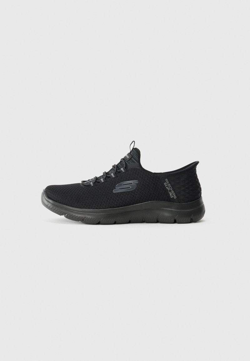 Black slip-on Skechers athletic shoe with mesh fabric, flexible sole, and pull tab on tongue, shown in left side profile on white background.