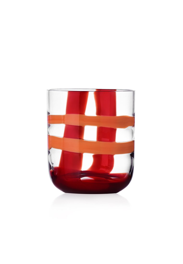 Przezroczysta szklanka z czerwono-pomarańczowymi, spiralnymi wzorami. Gładka faktura, lekko zaokrąglone dno i proste boki.
